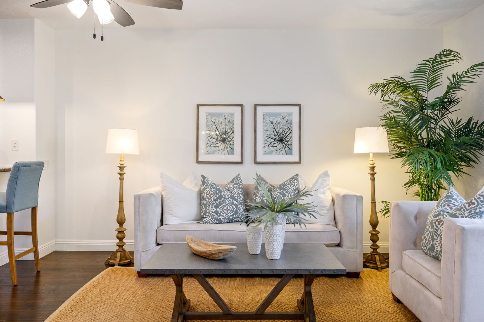 A cool, calm Southern California living space at midday with the air clearly handled — a plant, mugs on a low table, soft daylight across the sofa